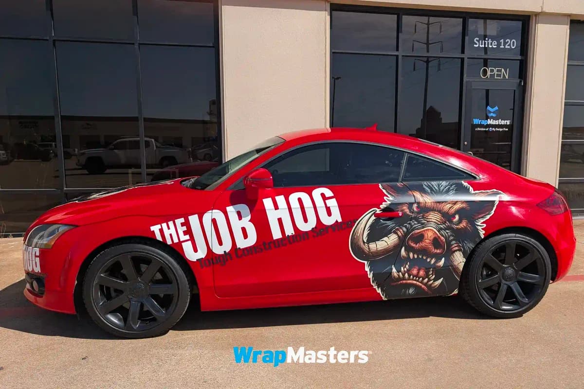 Red Audi TT wrapped as The Job Hog outside the WrapMasters facility in Denton