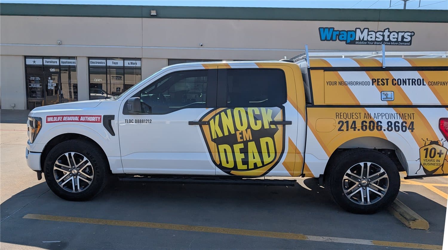 Knock Em Dead Pest Control truck wrap in white and yellow, designed and installed by WrapMasters