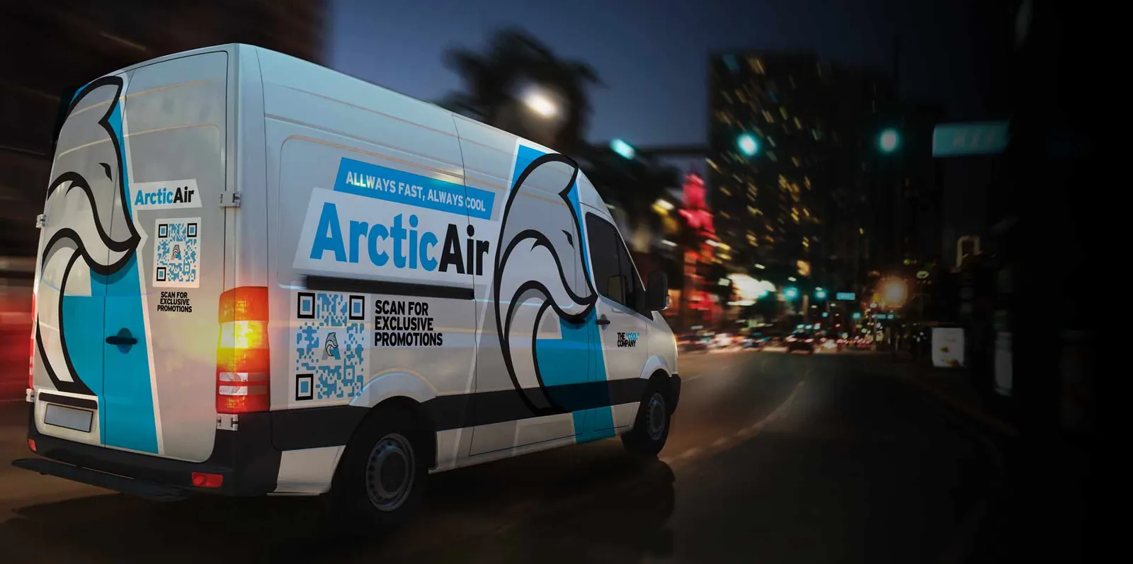 Arctic Air HVAC van wrap design shown at night in city traffic, white and light blue with a polar bear