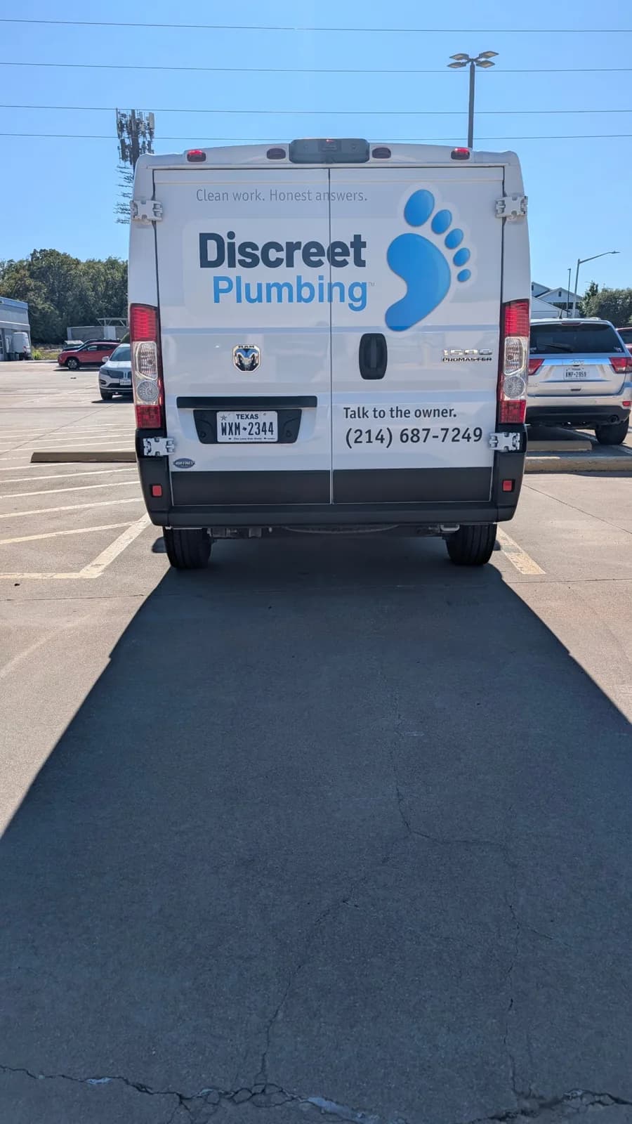 Discreet Plumbing van rear doors: name, footprint mark, Talk to the owner., and the phone number