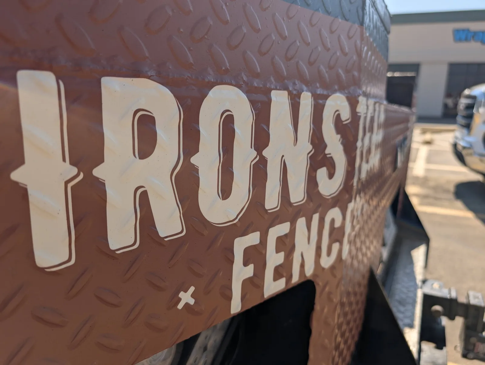 Ironstead Fence lettering on the diamond-plate flatbed