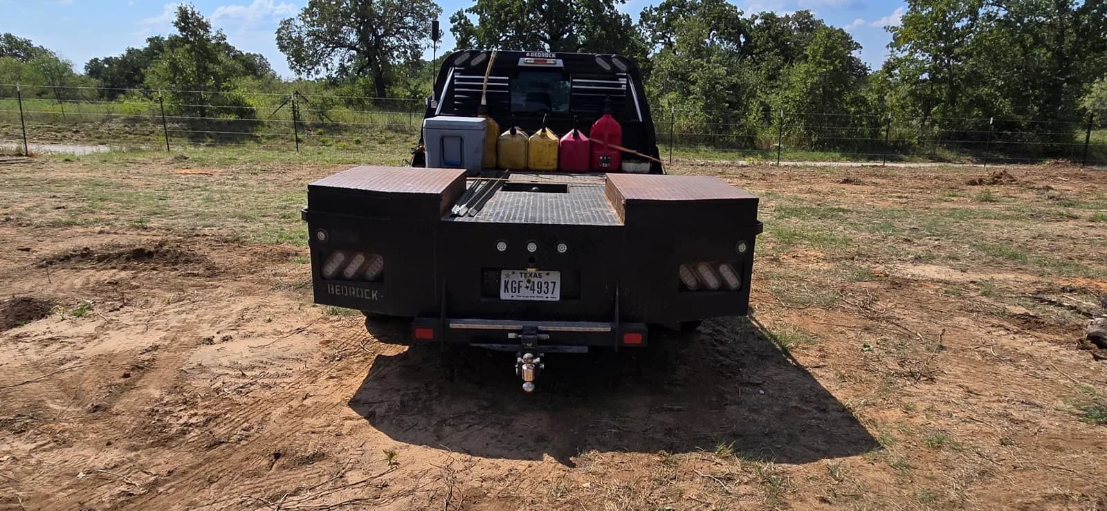 The back of the F-350 flatbed before the wrap: no name anywhere a trailing driver could read it