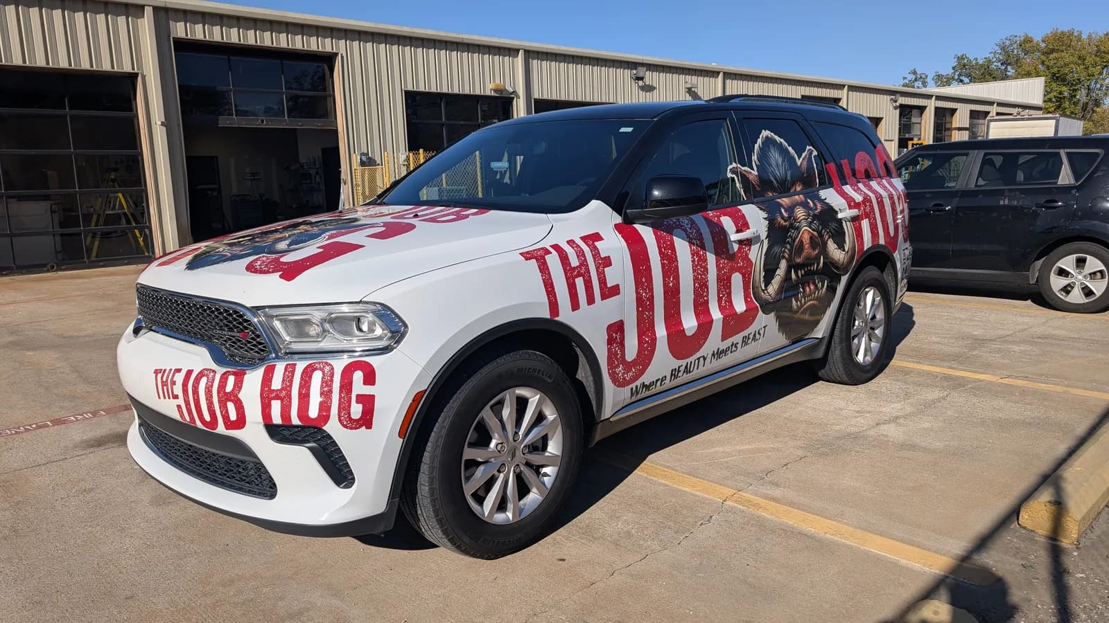 The Job Hog Dodge Durango wrap, front three-quarter view, by WrapMasters