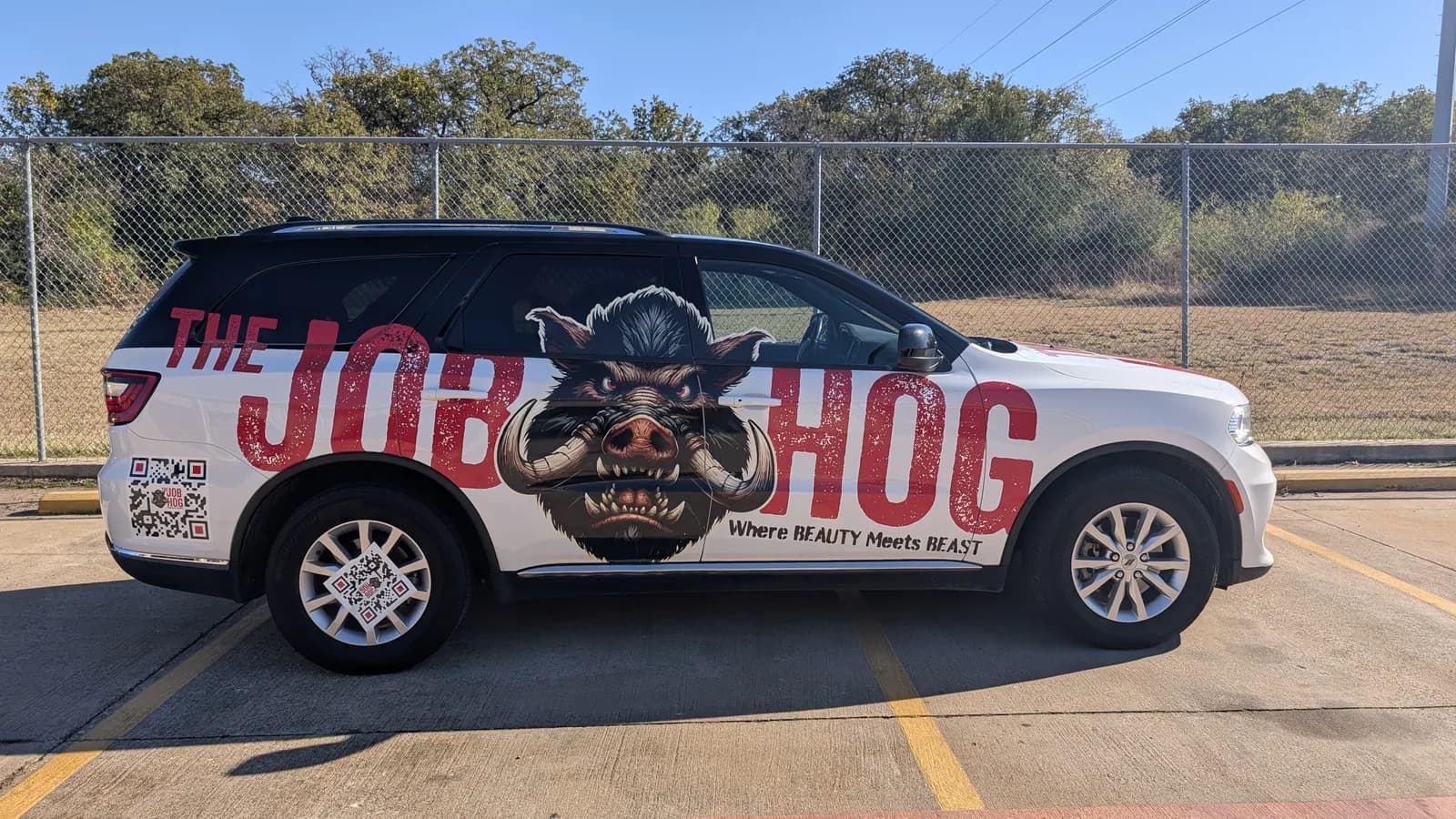 The Job Hog Dodge Durango wrap with the hog graphic and the line Where Beauty Meets Beast, by WrapMasters