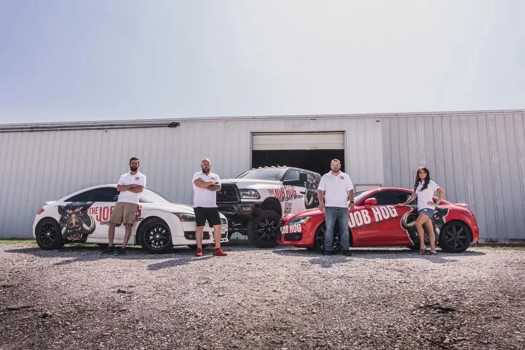 The Job Hog fleet after deployment: two wrapped Audi sports cars and a wrapped dually truck sharing one brand system