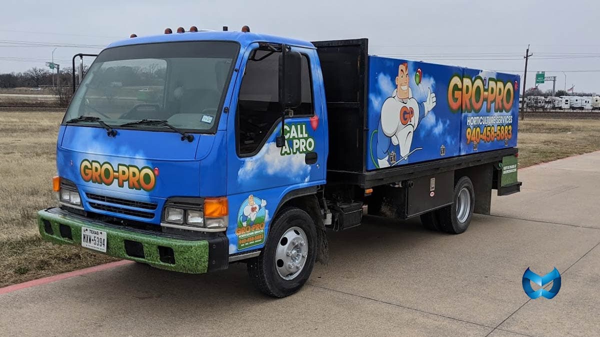 Gro-Pro Horticulture Services truck in a distinctive sky-blue livery with the name and phone number still leading the read