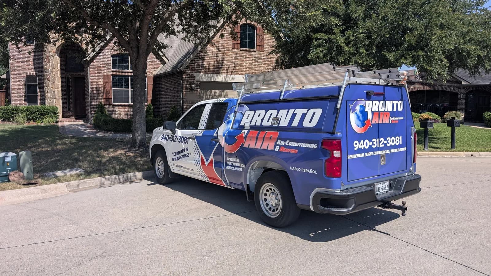 Pronto Air HVAC truck parked in a residential driveway, in view of the neighboring homes