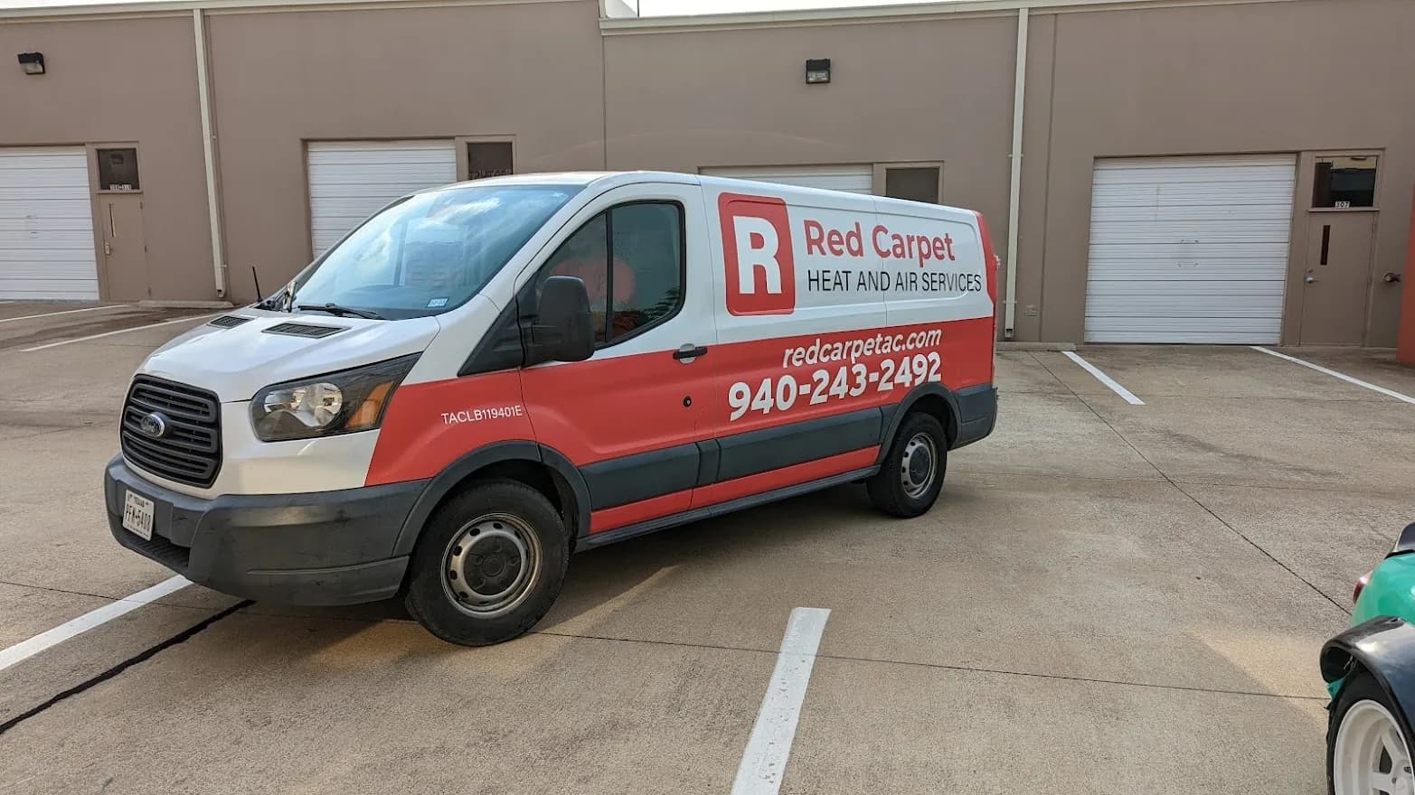 Red Carpet Heat and Air Ford Transit van with a red partial wrap over the white factory paint, by WrapMasters