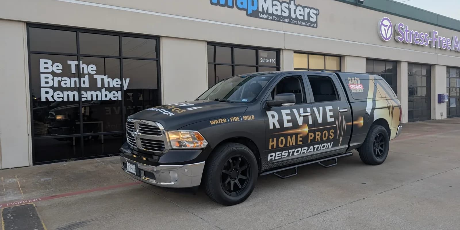 The same pickup after the wrap: Revive Home Pros Restoration across the doors, Water, Fire, Mold, and 24/7 Emergency Services