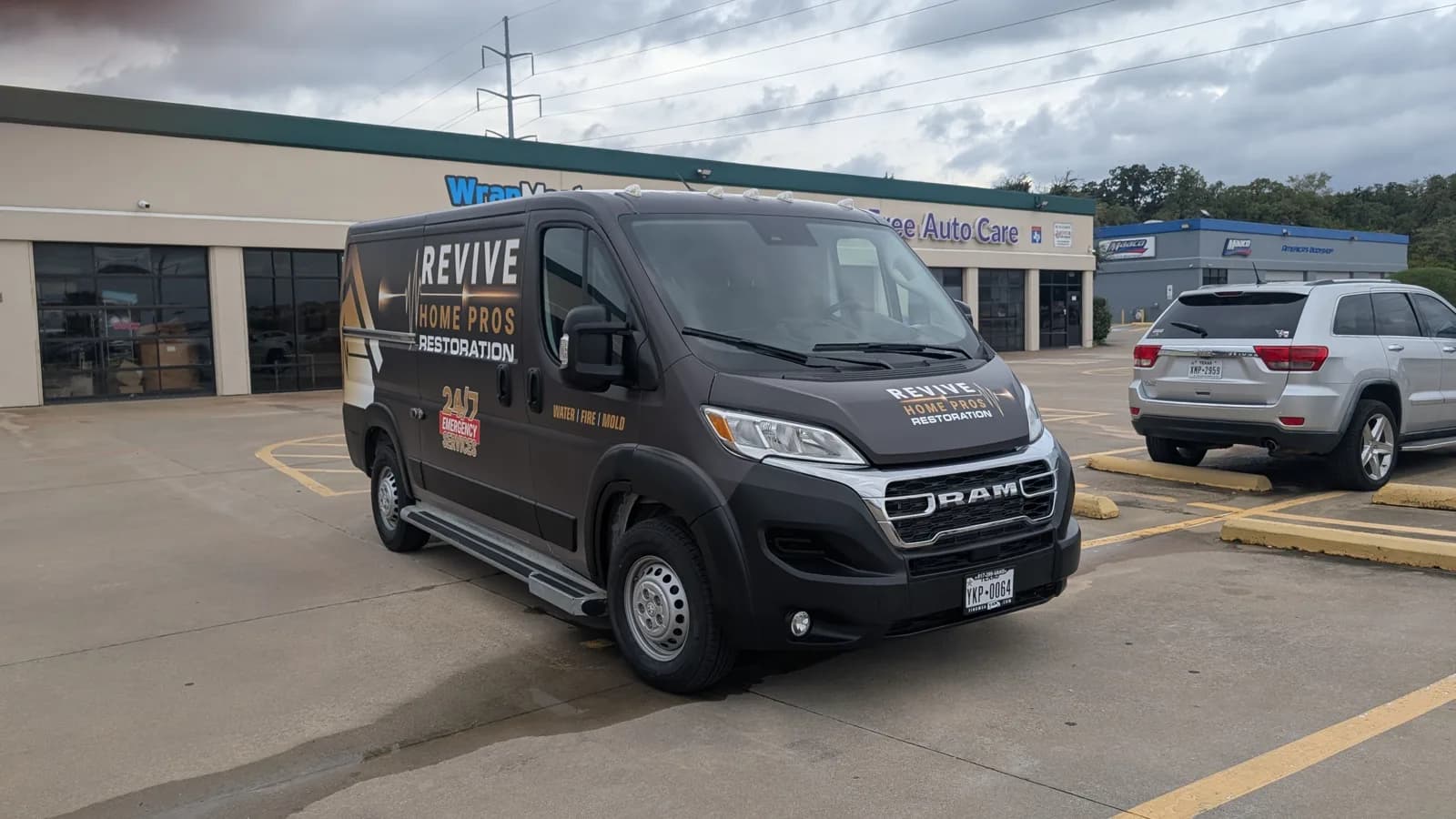 Revive Home Pros van front three-quarter view outside WrapMasters in Denton