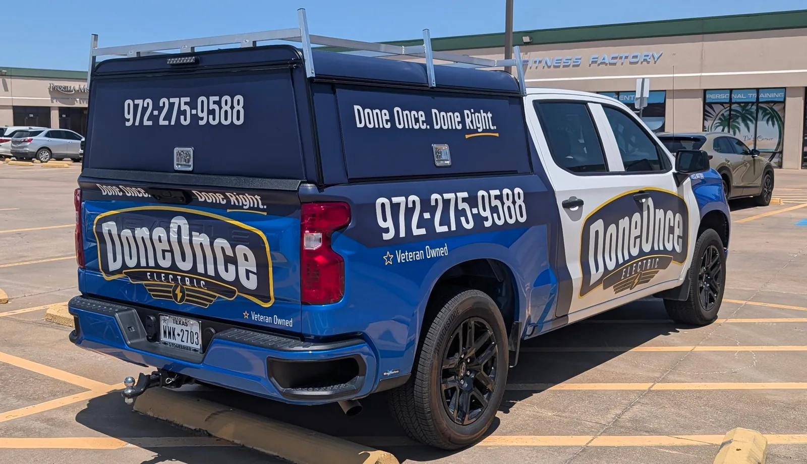 Done Once Electric pickup wrap with the promise Done Once. Done Right. on the topper and the tailgate